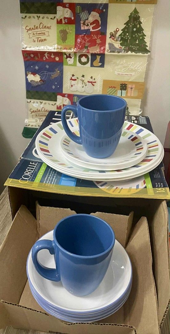 Authentic Corelle Livingware Memphis 16-Piece Dinnerware Set (Category: Dinnerware & Cutlery) located in Manila. Submitted by sterling_grace (Listing ID 1401037764, Image 3). Description: - Corelle Livingware Memphis 16-piece dinnerware set includes plates, bowls, and mugs. - The set features a white base with colorful striped accents. - The mugs are a solid blue color. - This durable Vitrelle glass dinnerware is designed for everyday use. - It i