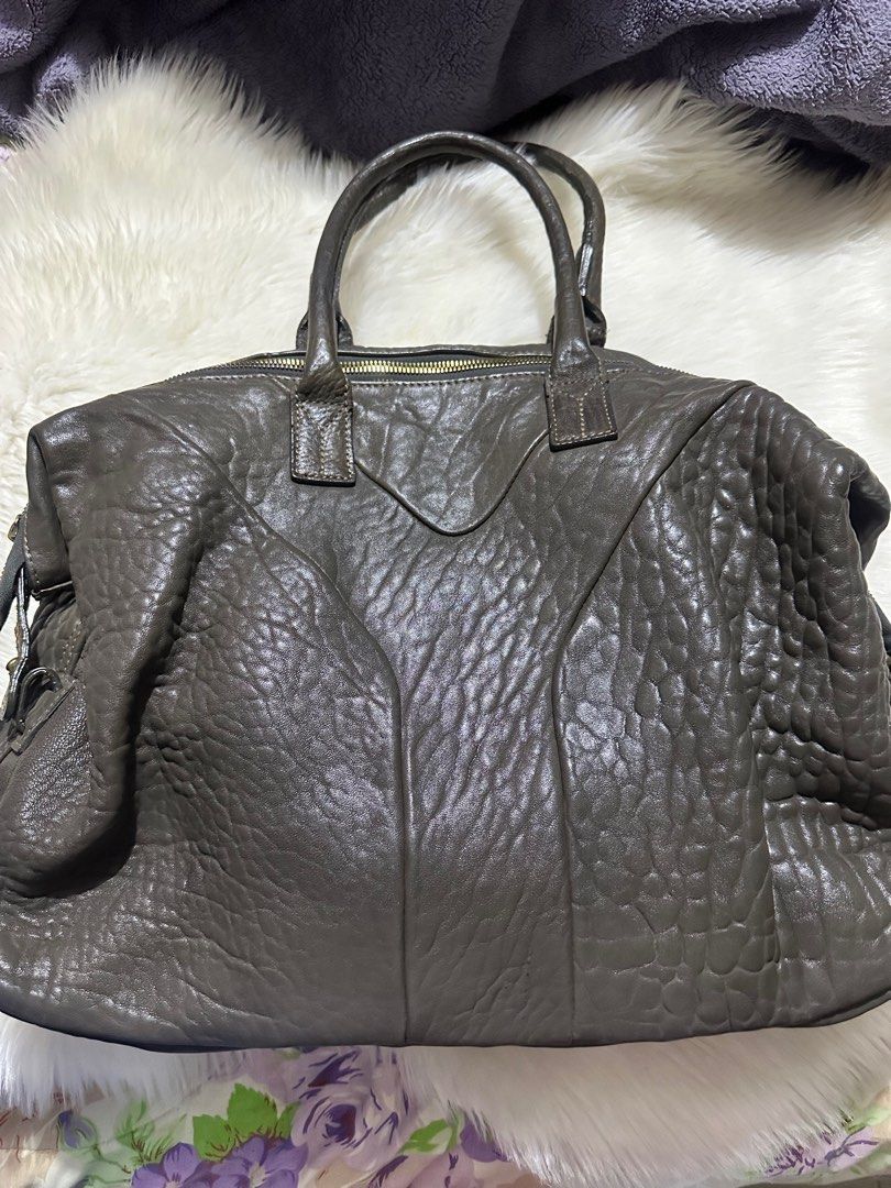 EASY Y$L GENUINE Leather Handbag (Category: Luxury Bags & Wallets) located in Paranaque City. Submitted by love1927 (Listing ID 1400976219, Image 1). Description: - Easy YSL handbag - Textured leather exterior - Dual top handles - Secure zip closure - Spacious interior compartment - Distinctive Y-shaped design - Elegant gold-toned hardware - Protective metal feet at base Large Size .