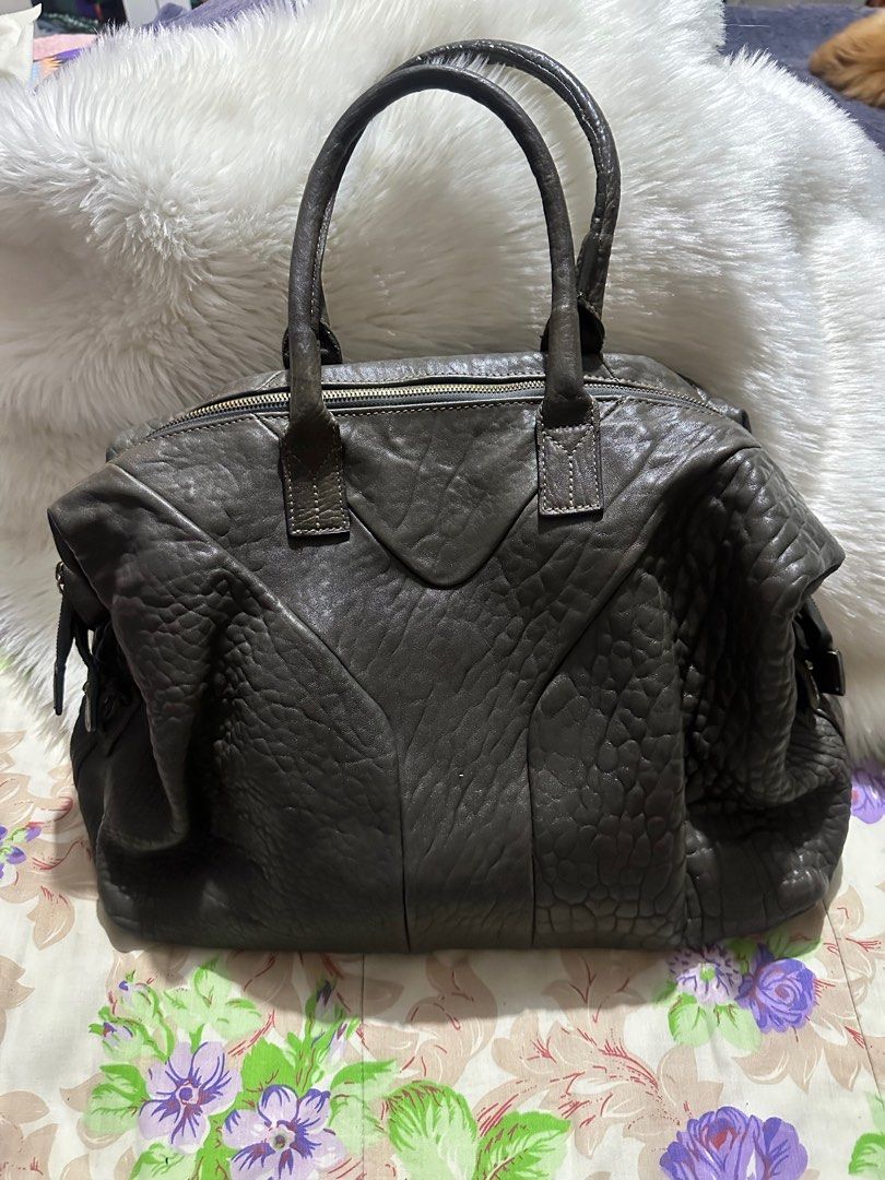 EASY Y$L GENUINE Leather Handbag (Category: Luxury Bags & Wallets) located in Paranaque City. Submitted by love1927 (Listing ID 1400976219, Image 3). Description: - Easy YSL handbag - Textured leather exterior - Dual top handles - Secure zip closure - Spacious interior compartment - Distinctive Y-shaped design - Elegant gold-toned hardware - Protective metal feet at base Large Size .