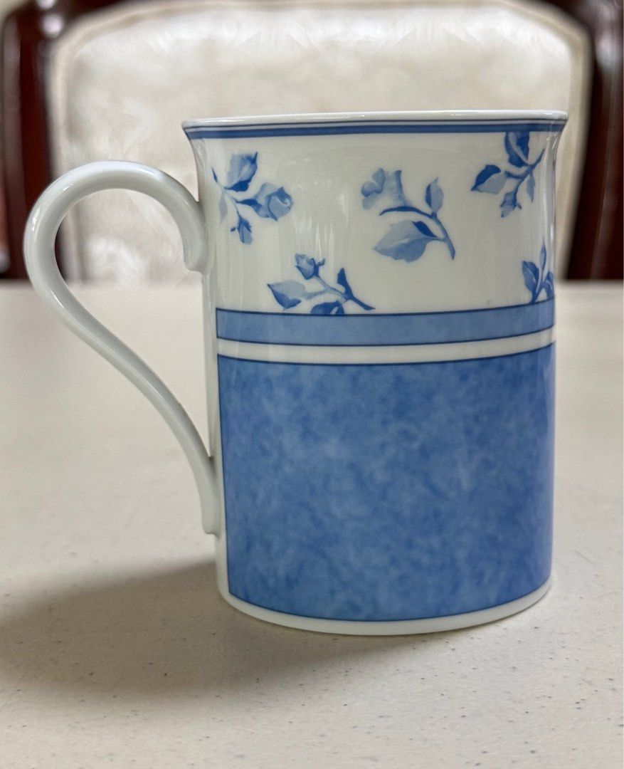 Hutschenreuther Summerdream Blue Mug (Category: Coffee & Tea Tableware) located in Quezon City. Submitted by meggoquingco (Listing ID 1401049893, Image 2). Description: Hutschenreuther mug from the Summerdream Blue collection. It is made in Germany. The mug has a white base with a handle. The bottom of the mug features the brand name, collection name, and the country of origin. The mug has a simple, elegant design..