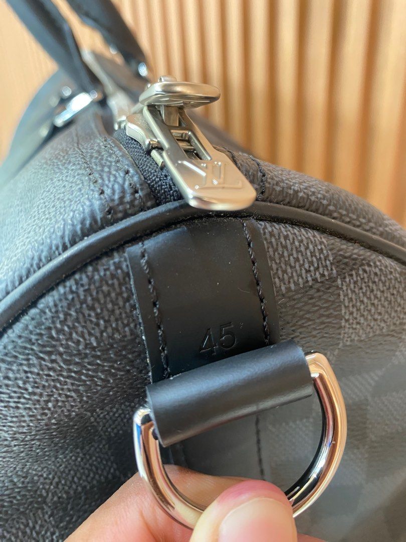 Louis Vuitton Damier Graphite Canvas Keepall 45 (Category: Luxury Bags & Wallets) located in Panabo. Submitted by dequintosj92155 (Listing ID 1401162225, Image 2). Description: - Louis Vuitton Keepall 45 Duffle Bag - Damier Graphite canvas - Black leather handles and trim - Silver-tone zipper with Louis Vuitton logo - Spacious interior - Made in France -Not Included (Strap, Name Tag) Bag Only.