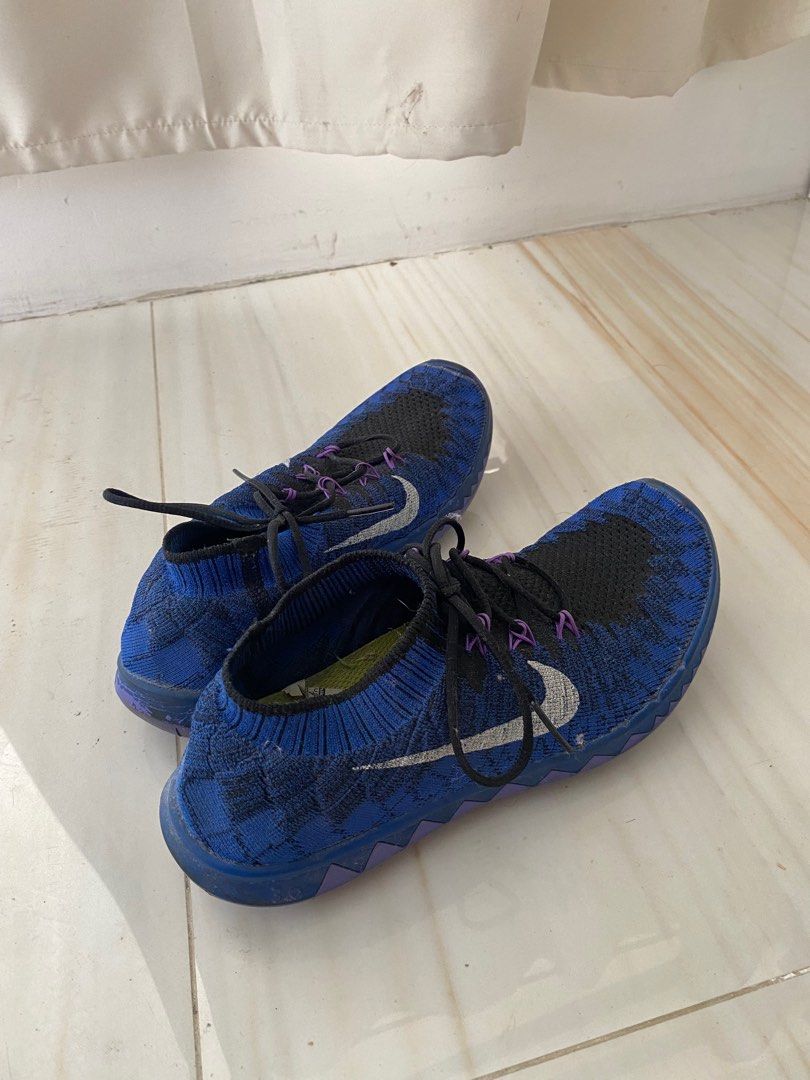 Nike Free RN Flyknit 2017 Running Shoes (Category: Sneakers) located in Manila. Submitted by sparkfinds (Listing ID 1401036058, Image 2). Description: Nike Free RN Flyknit 2017 running shoes in blue and black. Features a Flyknit upper, Nike swoosh on the sides, and black laces with purple accents. The soles are blue and purple. The shoes appear to be used..