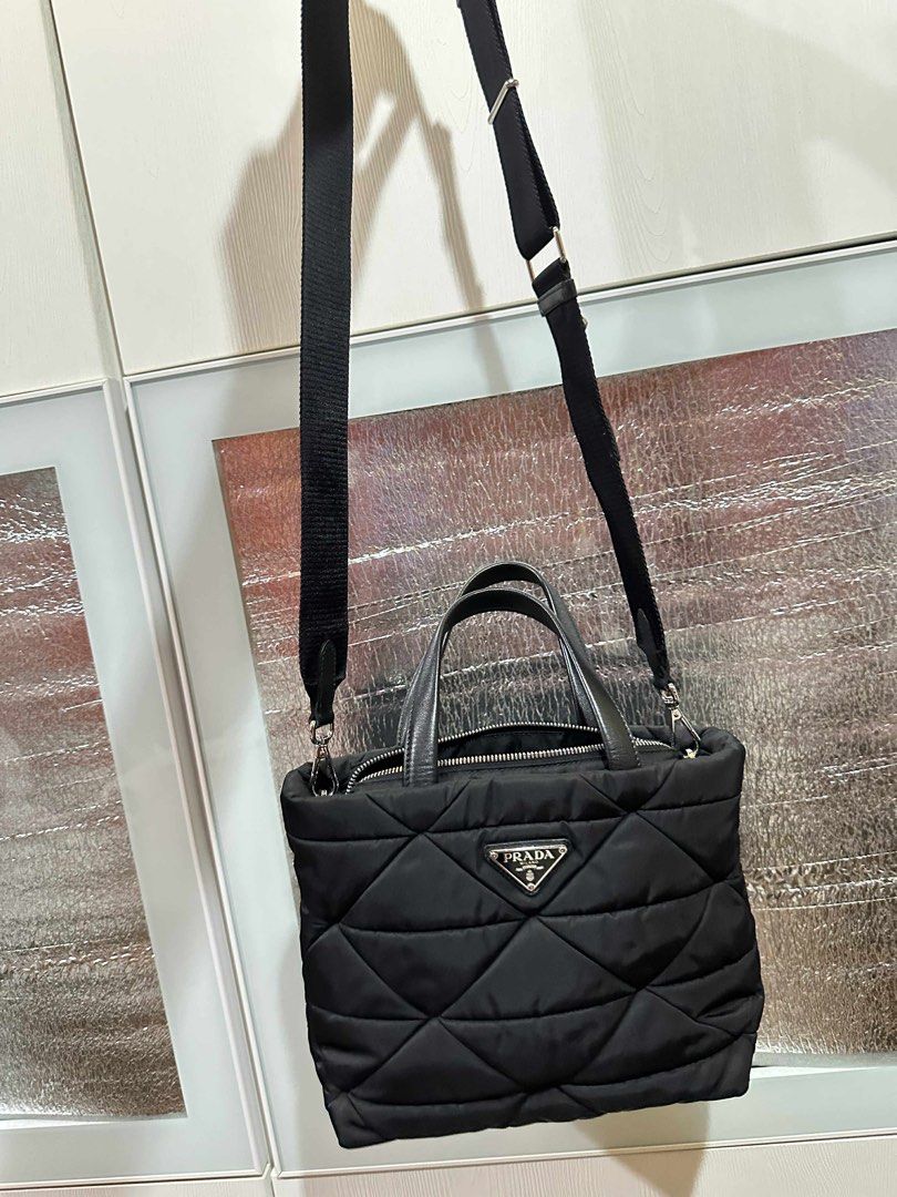 Prada Quilted Tote Bag with Pouch (Category: Luxury Bags & Wallets) located in Taguig. Submitted by thummert (Listing ID 1401074304, Image 1). Description: - Authentic Prada tote bag - Quilted design - Detachable shoulder strap - Top handles - Matching small pouch included - Secure zipper closure - Prada logo on front and strap - Silver hardware.