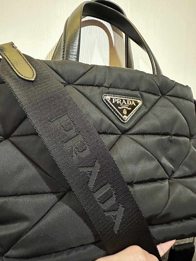 Prada Quilted Tote Bag with Pouch (Category: Luxury Bags & Wallets) located in Taguig. Submitted by thummert (Listing ID 1401074304, Image 3). Description: - Authentic Prada tote bag - Quilted design - Detachable shoulder strap - Top handles - Matching small pouch included - Secure zipper closure - Prada logo on front and strap - Silver hardware.