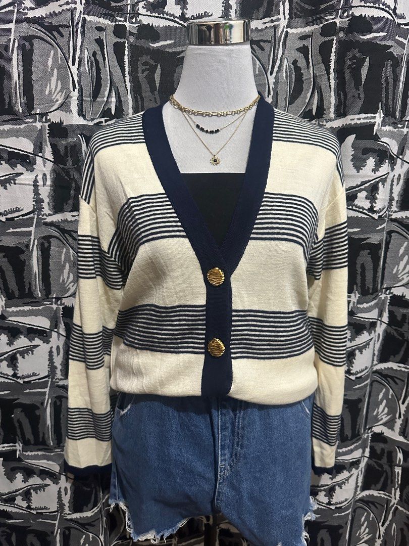 Striped Cardigan with Gold Buttons (Category: Coats, Jackets and Outerwear) located in Antipolo. Submitted by declutteringsizzy (Listing ID 1401160035, Image 1). Description: - Cream-colored cardigan - Navy blue stripes and trim - Gold buttons - Two front pockets - Long sleeves - V-neckline - Knit material - Size: Large to XL - Width = 23in” - Length = 31in”.