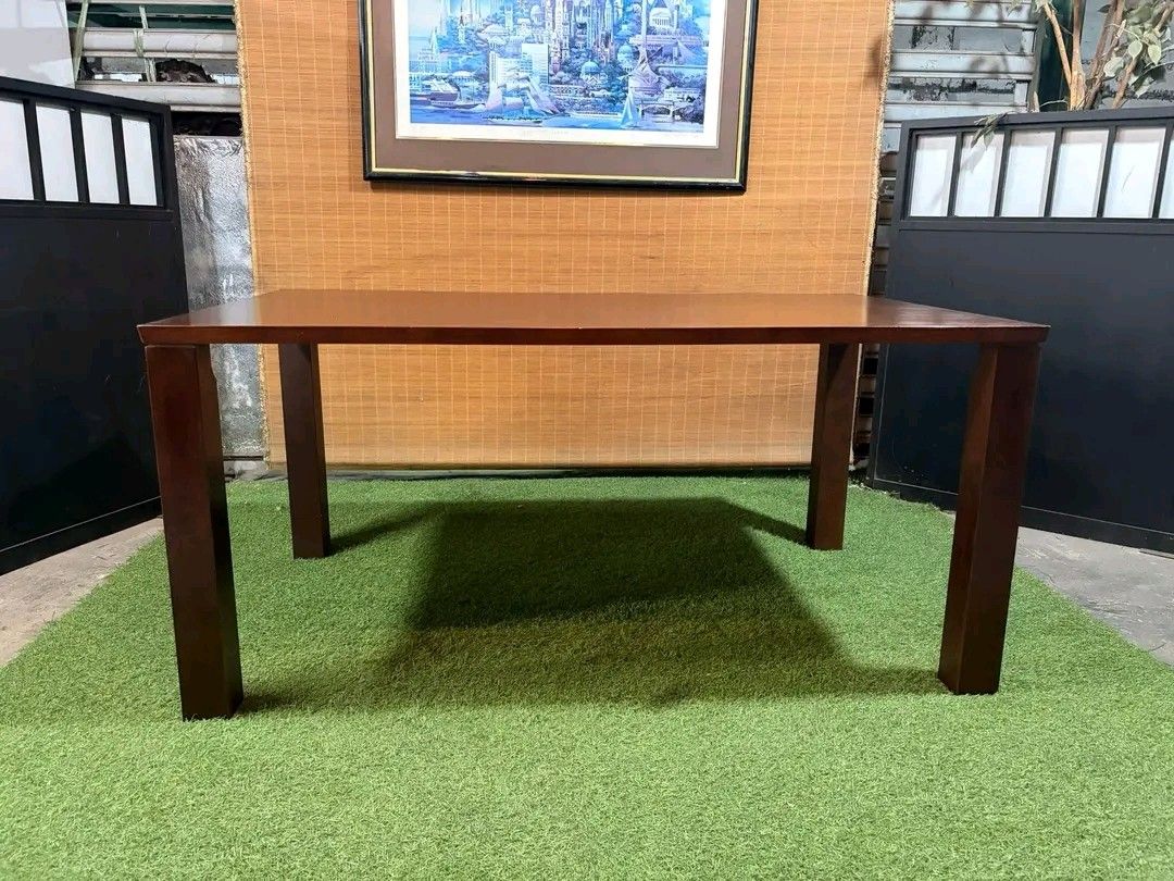 Wooden Dining Table (Category: Tables & Sets) located in Manila. Submitted by eloizavill76462 (Listing ID 1401047500, Image 1). Description: - Solid wood dining table - Dark brown finish - Rectangular tabletop - Supported by four square legs - Suitable for dining or workspace - Simple and elegant design.