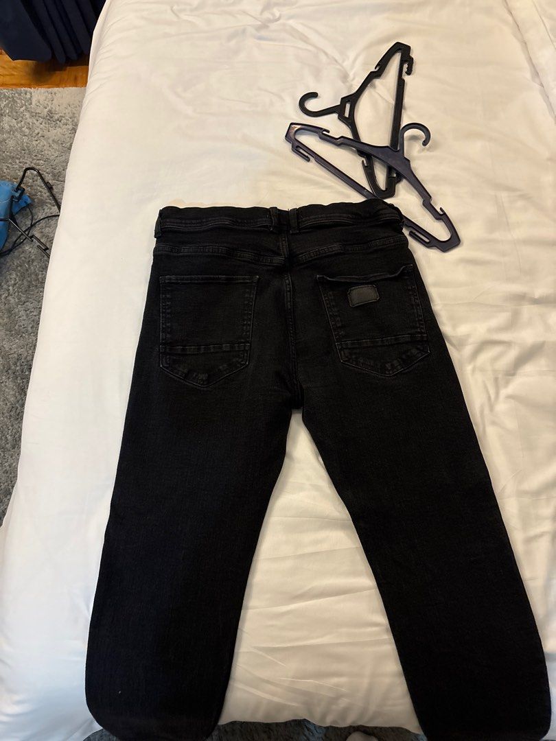 Zara Black Jeans (Category: Joggers) located in Manila. Submitted by junjun_jomar (Listing ID 1401108787, Image 2). Description: Black jeans from Zara. Features a button and zipper closure. Has two front pockets and two back pockets. The jeans appear to be a straight-leg fit. The fabric looks to be a medium-weight denim. The jeans are a solid black color..