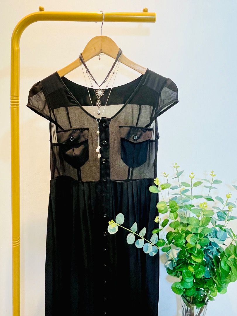 Black Maxi Dress with Sheer Overlay (Category: Dresses) located in Caloocan City. Submitted by allaboutaria (Listing ID 1396138604, Image 2). Description: Elegant black maxi dress featuring a sheer overlay on the bodice. It has short sleeves, two front pockets, and a button-down front. The dress has a pleated skirt, adding a touch of sophistication. Perfect for various occasions, offering a stylish and comfortable fit..