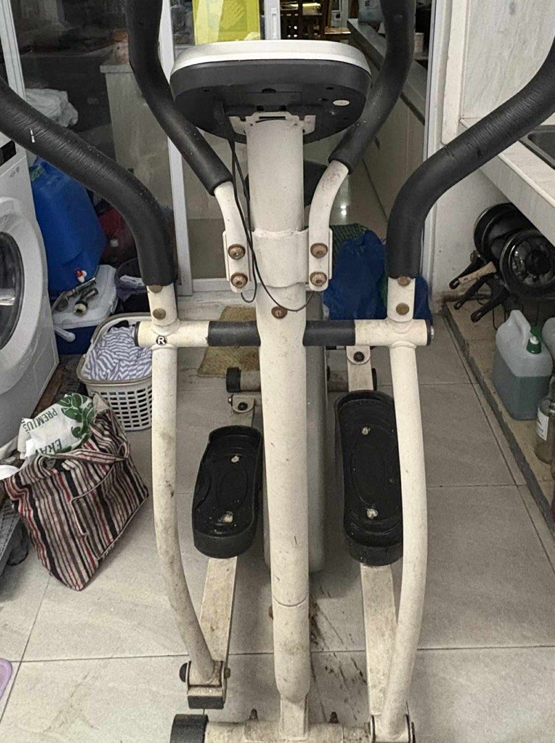 Elliptical Trainer exercise bike gym equipment (Category: Cardio & Fitness Machines) located in Manila. Submitted by jiden26 (Listing ID 1396247225, Image 1). Description: - needs deep cleaning lang - weights are still usable - Elliptical trainer with digital display - Adjustable resistance levels - Includes foot pedals and upper body handles - Stylish white frame with black accents - In good working condition.