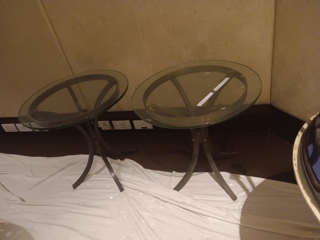 Glass Top Side Table (Category: Tables & Sets) located in Las Pinas. Submitted by jesus1smysavi0r (Listing ID 1396120890, Image 2). Description: ON SALE!! Elegant side table with a round glass top and a dark metal frame. The table has a unique curved leg design. It's perfect for small spaces or as an accent piece. The glass top provides a sleek and modern look. It is ideal for placing drinks, books, or decorative items..
