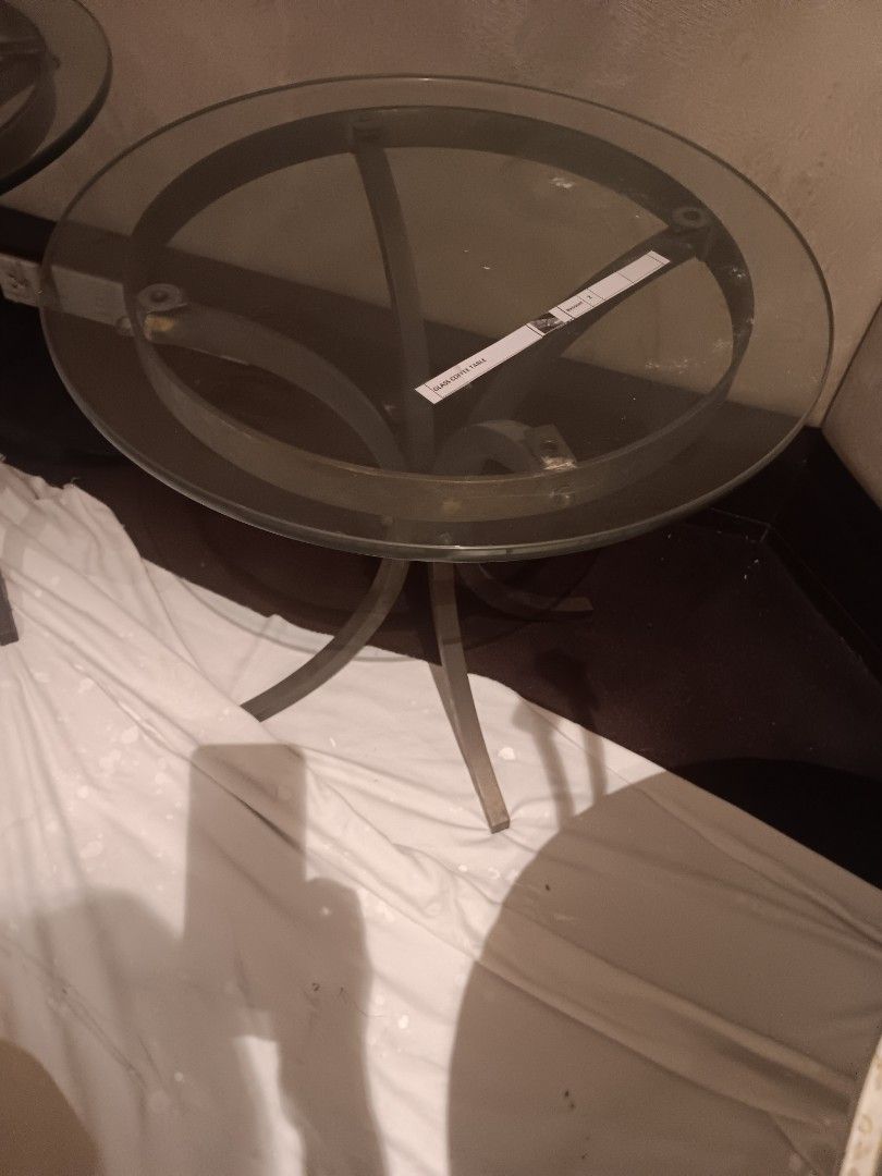 Glass Top Side Table (Category: Tables & Sets) located in Las Pinas. Submitted by jesus1smysavi0r (Listing ID 1396120890, Image 1). Description: ON SALE!! Elegant side table with a round glass top and a dark metal frame. The table has a unique curved leg design. It's perfect for small spaces or as an accent piece. The glass top provides a sleek and modern look. It is ideal for placing drinks, books, or decorative items..