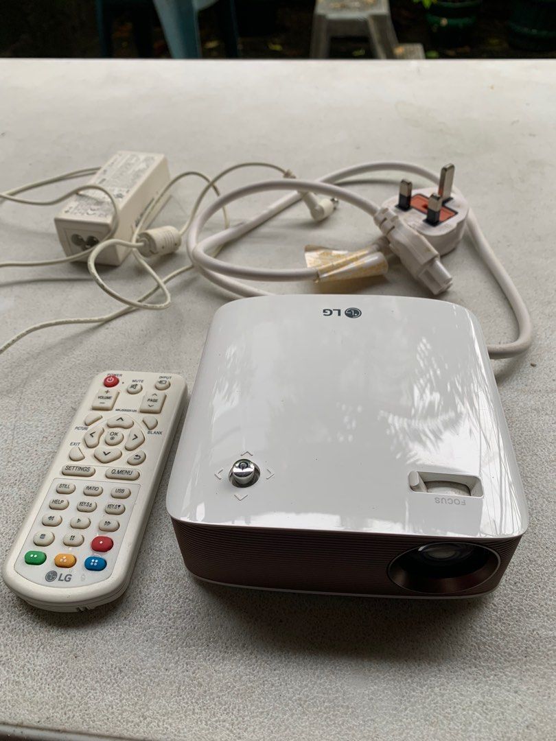 LG Portable LED Cinebeam Projector (PH150G) (Category: Projectors) located in Las Pinas. Submitted by jomz80s (Listing ID 1396162769, Image 3). Description: - LG PH150G portable projector - Includes remote control and power adapter - Connectivity: HDMI, USB, headphone, Bluetooth - Color: White and brown - Model: PH150G - Made in Korea MOP: Gcash or Maya MOD: Meetup in Las Pinas or Pickup at buyer's expense Location: Las Pinas City Please do not h