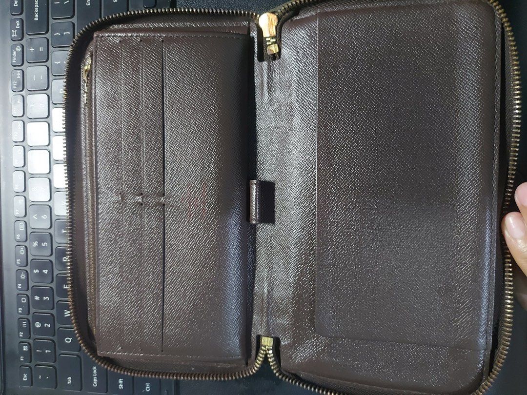 Louis Vuitton Damier Ebene Zippy Organizer Wallet (Category: Luxury Bags & Wallets) located in Manila. Submitted by venven3853 (Listing ID 1396117303, Image 2). Description: - 💯 Authentic Louis Vuitton Damier Ebene Zippy Organizer Wallet - Brown Damier Ebene checkered exterior - Secure zip-around closure - Interior with multiple card slots and compartments - Made in France stamp - Gold-toned zipper - Serial number visible in photo - No lagkit-la
