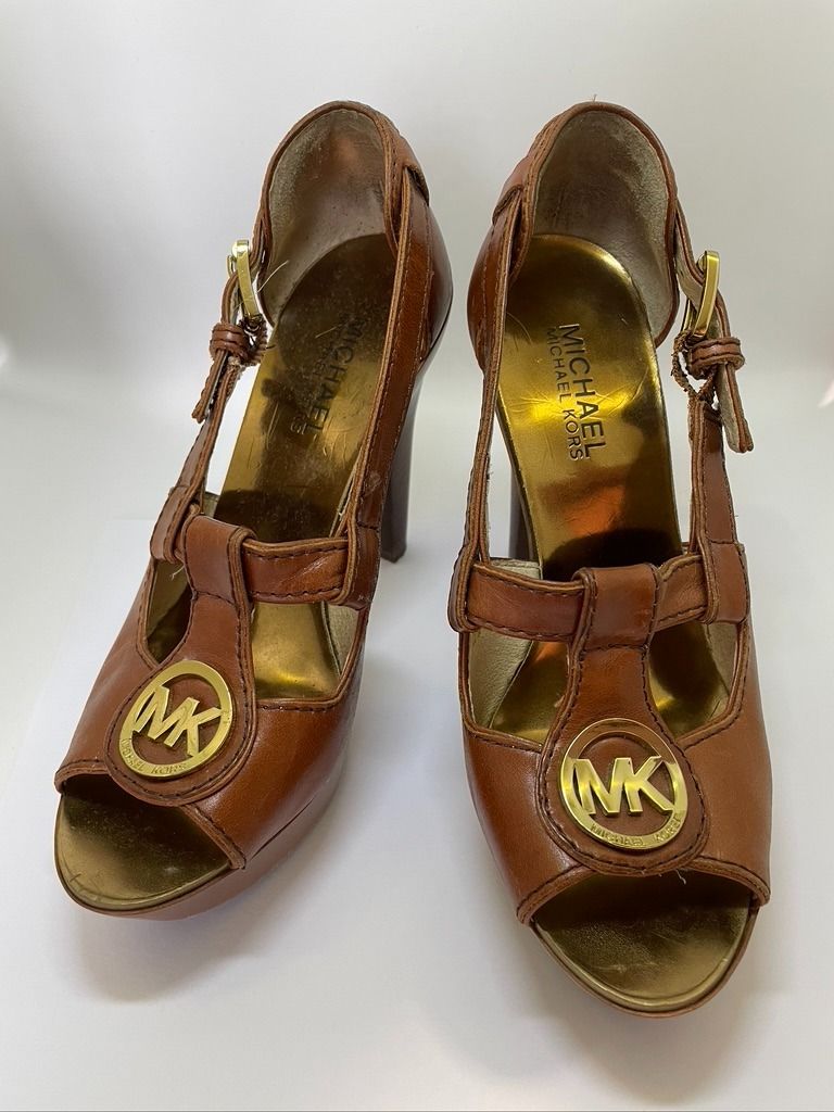 Michael Kors Brown Leather Chunky Platform Heels Sandals (Category: Flats & Sandals) located in San Juan City. Submitted by declutterdiariesmnl (Listing ID 1396184493, Image 2). Description: - Authentic Michael Kors sandals - Brown leather - Size: 5M - T-strap design with MK logo - Platform sole - Heel Height 4.5inches - Embossed MK logo on soles - Made in China - Leather upper, rubber outsole Seller's Notes: In good condition. Lightly used, but 