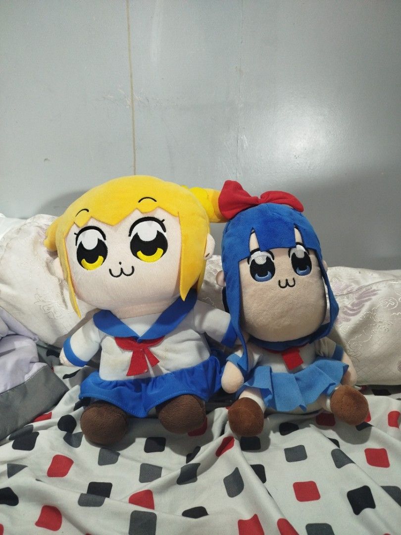 Pop Team Epic Plush SET (Category: Plushies & Soft Toys) located in Baguio. Submitted by shrimpytrinkies (Listing ID 1396186152, Image 1). Description: - Pop Team Epic plushies featuring Popuko and Pipimi. - Popuko has yellow hair. - Pipimi has blue hair and a red bow. - Both plushies wear their signature outfits. - Includes the Pop Team Epic tag..