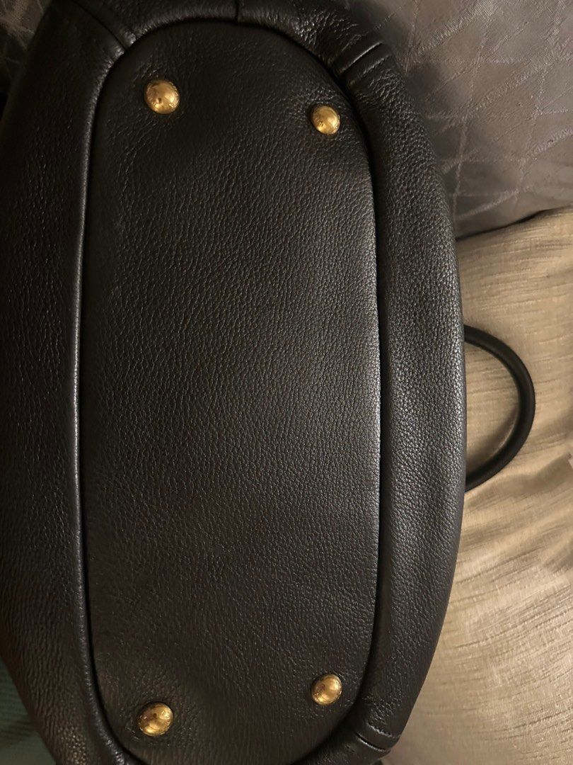 Prada Leather Handbag (Category: Luxury Bags & Wallets) located in Manila. Submitted by kaitdeclutters (Listing ID 1396209878, Image 3). Description: - Authentic Prada handbag - Black textured leather - Gold-tone hardware - Top handle and detachable shoulder strap - Includes authenticity cards - Protective feet All authenticity cards still included Original dust bag included .