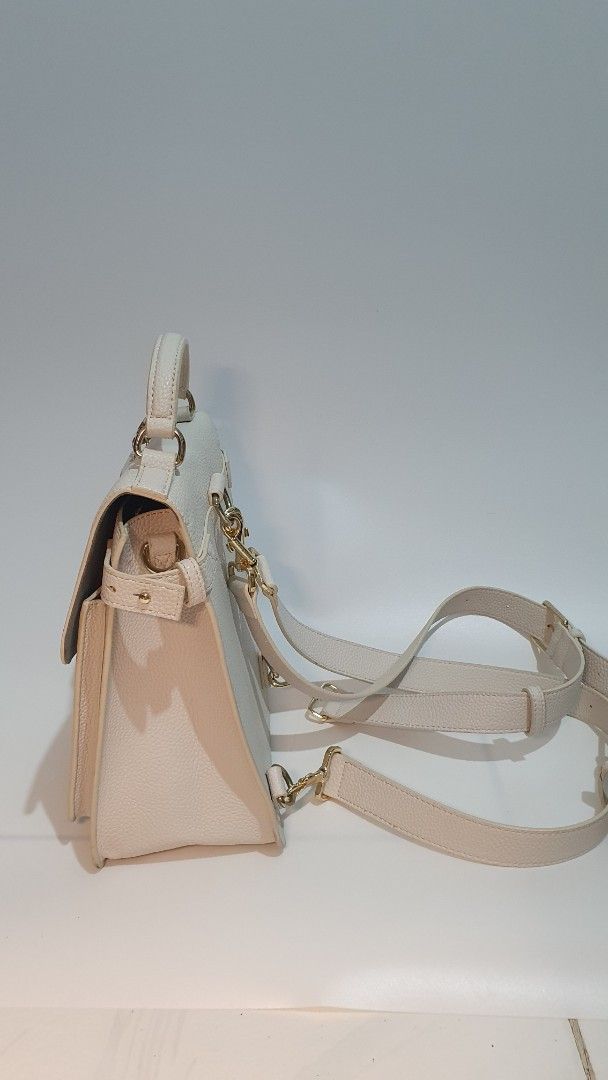 Tommy Hilfiger Convertible Handbag (Category: Luxury Bags & Wallets) located in Cabanatuan. Submitted by nix.cynn (Listing ID 1396207218, Image 2). Description: - never used - Cream-colored Tommy Hilfiger handbag - Top handle and detachable shoulder strap (crossbody/backpack) - Flap closure with gold-tone logo - Interior zippered pocket - Gold-tone hardware - Textured exterior.