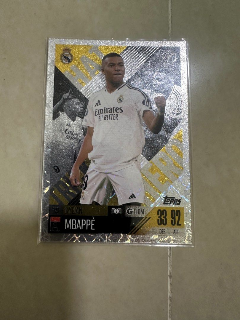 Topps Match Attax Mbappe Real Madrid Card (Category: Raw Cards) located in Singapore. Submitted by numbered-card-shop (Listing ID 1396158290, Image 2). Description: - Topps Match Attax card - Features Kylian Mbappe - Playing for Real Madrid - Comes in a protective sleeve - Ideal for collectors and fans.