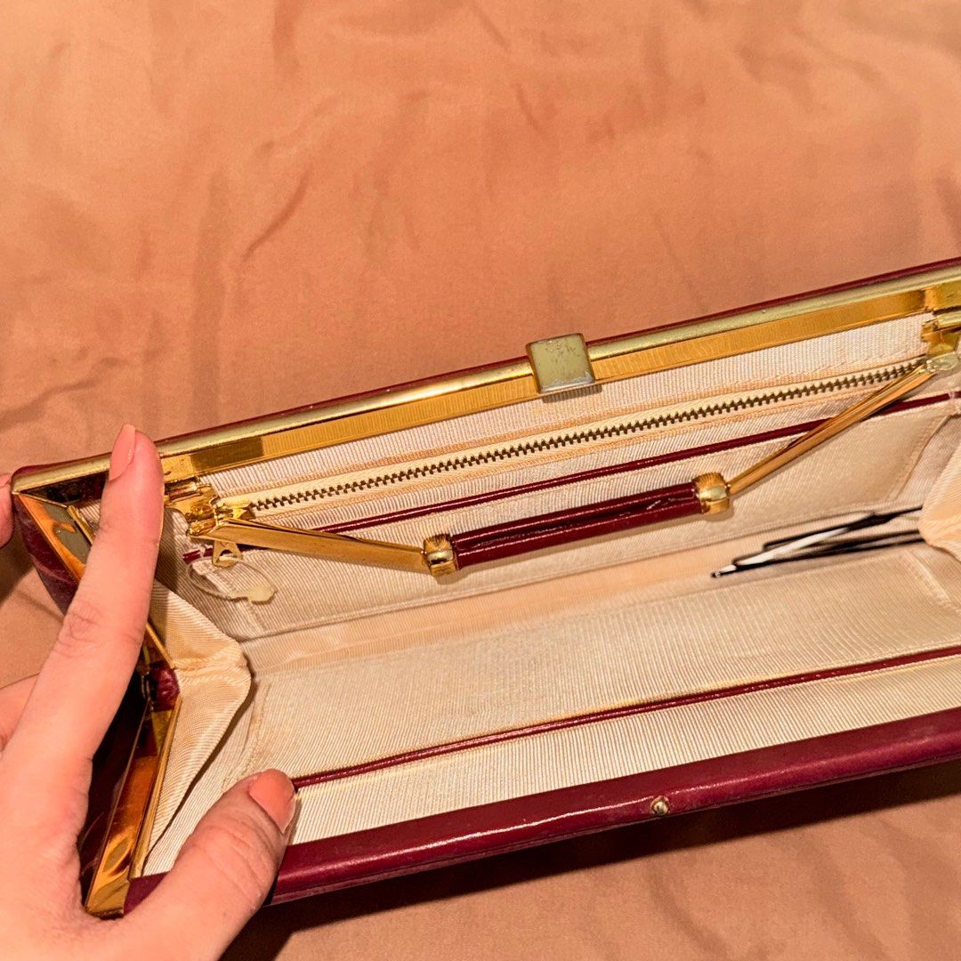Vintage Maroon Handbag with Gold Handle (Category: Luxury Bags & Wallets) located in Marikina City. Submitted by declutter__me (Listing ID 1396279258, Image 3). Description: - used once only - Vintage maroon handbag - Gold-toned handle and frame - Secure clasp closure - Interior zippered pocket - Classic, structured design - Smooth, leather-like material - needs minimal cleaning only.
