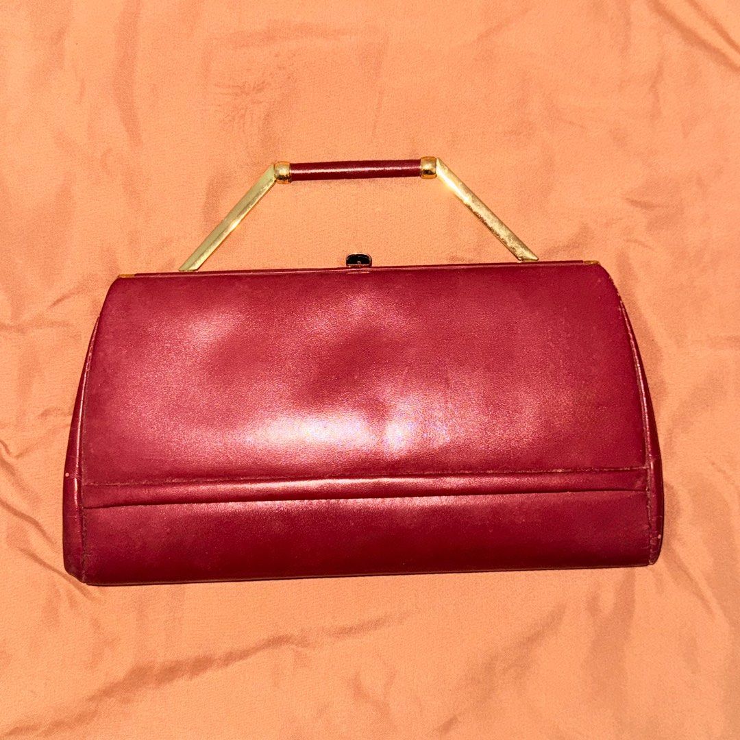 Vintage Maroon Handbag with Gold Handle (Category: Luxury Bags & Wallets) located in Marikina City. Submitted by declutter__me (Listing ID 1396279258, Image 1). Description: - used once only - Vintage maroon handbag - Gold-toned handle and frame - Secure clasp closure - Interior zippered pocket - Classic, structured design - Smooth, leather-like material - needs minimal cleaning only.