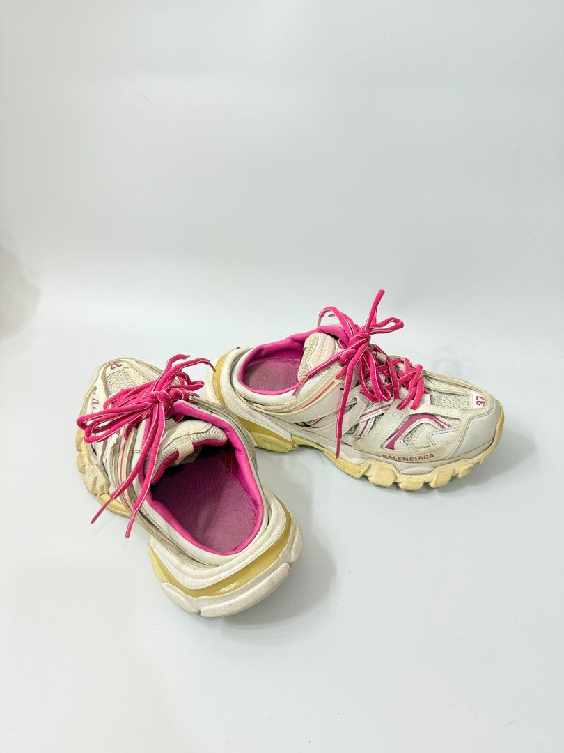 Balenciaga Track Mule Sneakers (Category: Sneakers) located in Manila. Submitted by ninalumbang (Listing ID 1401345127, Image 1). Description: - Balenciaga Track Mule sneakers - Color: White with pink accents - Size: 37 - Design: Lace-up with Balenciaga logo - Sole: Chunky - Interior: Pink.