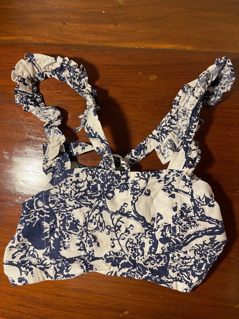 Blue and White Floral Crop Top (Category: Others Tops) located in Quezon City. Submitted by d.archives (Listing ID 1401211717, Image 1). Description: Backless tie linen top Crop top features a beautiful blue and white floral pattern. It has ruffled straps and a square neckline. It's a stylish piece that can be paired with high-waisted bottoms for a chic look. Helping tags: cariño, araw, anika, vin the line.