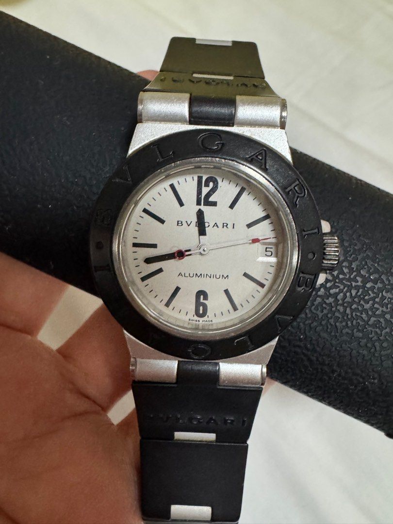 Bvlgari Aluminium Watch (Category: Luxury Watches) located in Paranaque City. Submitted by lmp08 (Listing ID 1401212697, Image 1). Description: - Bvlgari Aluminium watch - size 32mm (womens) - White dial - Black bezel - Black rubber strap - Date display at 3 o'clock - Dial markings: "ALUMINIUM" and "SWISS MADE" *with cracks on the rubber strap *no inclusions, guaranteed authentic .