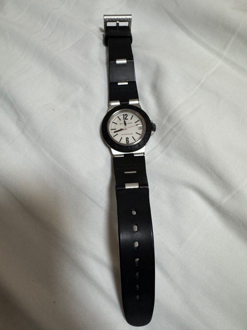 Bvlgari Aluminium Watch (Category: Luxury Watches) located in Paranaque City. Submitted by lmp08 (Listing ID 1401212697, Image 3). Description: - Bvlgari Aluminium watch - size 32mm (womens) - White dial - Black bezel - Black rubber strap - Date display at 3 o'clock - Dial markings: "ALUMINIUM" and "SWISS MADE" *with cracks on the rubber strap *no inclusions, guaranteed authentic .