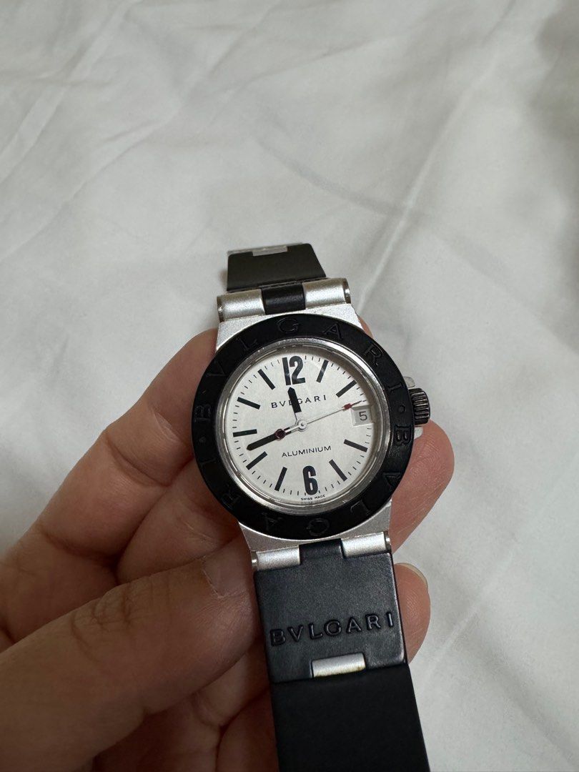 Bvlgari Aluminium Watch (Category: Luxury Watches) located in Paranaque City. Submitted by lmp08 (Listing ID 1401212697, Image 2). Description: - Bvlgari Aluminium watch - size 32mm (womens) - White dial - Black bezel - Black rubber strap - Date display at 3 o'clock - Dial markings: "ALUMINIUM" and "SWISS MADE" *with cracks on the rubber strap *no inclusions, guaranteed authentic .