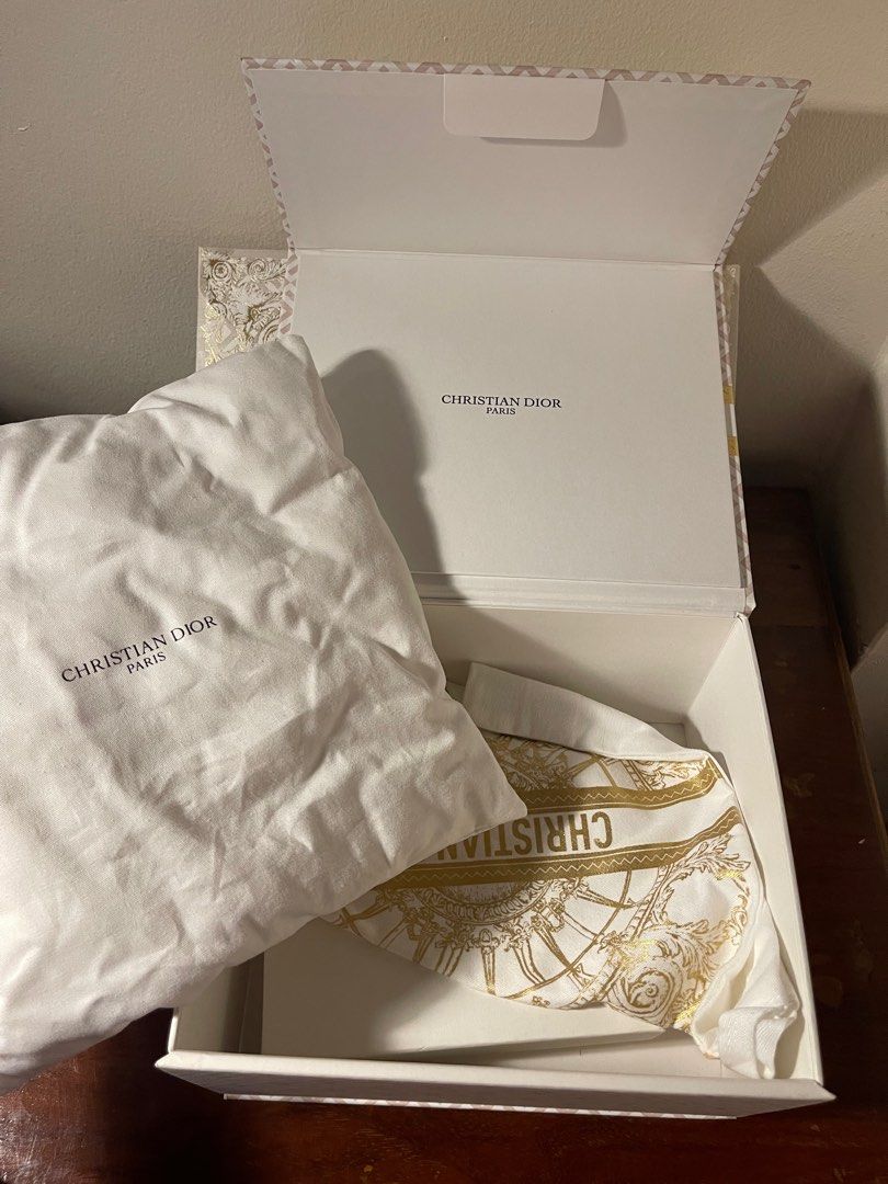 Christian Dior Gift Box (Category: Luxury Accessories) located in Quezon City. Submitted by d.archives (Listing ID 1401175828, Image 2). Description: Christian Dior gift box. Includes box, dust bag, and pillow and gift bag. The box features a gold and white design with the Christian Dior logo. Perfect for gifting or storing luxury items..
