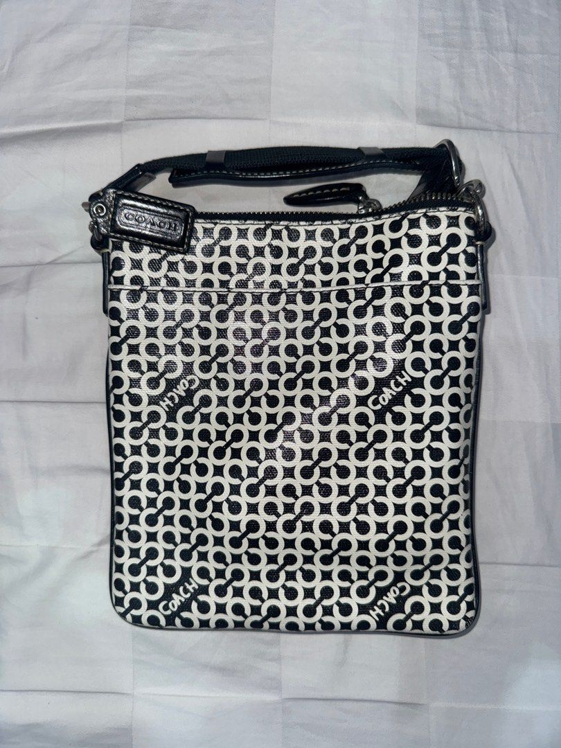 Coach Signature Crossbody Bag (Category: Luxury Bags & Wallets) located in Manila. Submitted by decluterrrr (Listing ID 1401296428, Image 2). Description: - Condition: barely used (<10 times), stored properly - No inclusions - Fits essentials such as all phones and long wallets - Coach crossbody bag - Signature black and white pattern - Zip closure - Adjustable strap - Exterior pocket - Coach logo detail.