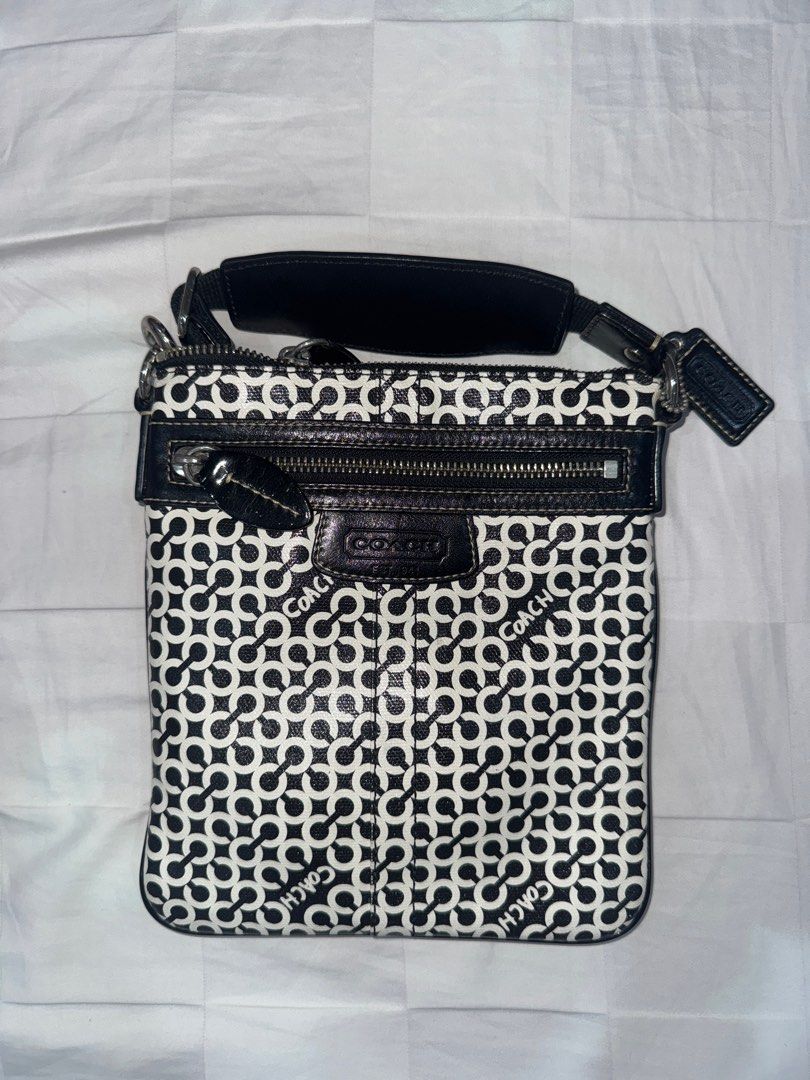 Coach Signature Crossbody Bag (Category: Luxury Bags & Wallets) located in Manila. Submitted by decluterrrr (Listing ID 1401296428, Image 1). Description: - Condition: barely used (<10 times), stored properly - No inclusions - Fits essentials such as all phones and long wallets - Coach crossbody bag - Signature black and white pattern - Zip closure - Adjustable strap - Exterior pocket - Coach logo detail.