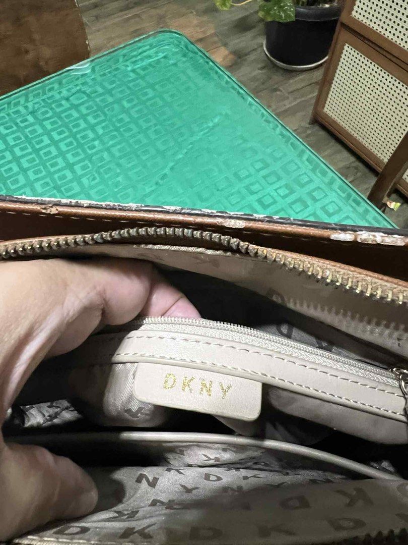 DKNY Brown Tote Bag with Chain Straps (Category: Luxury Bags & Wallets) located in Malabon City. Submitted by levineabby (Listing ID 1401343018, Image 3). Description: - DKNY brown tote bag - Features DKNY logo pattern - Chain and leather straps - Exterior pocket - Zippered main compartment - Interior DKNY label - Shows wear on edges and zipper area.