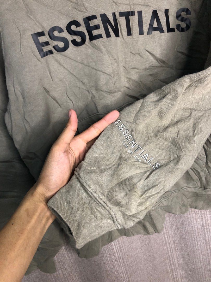Fear of God Essentials Hoodie (Category: Hoodies) located in Quezon City. Submitted by yeahsource222 (Listing ID 1401322150, Image 3). Description: - Essentials hoodie - Muted green color - Black Essentials logo print - Features logo on front and sleeve - Kangaroo pocket - Drawstring hood.