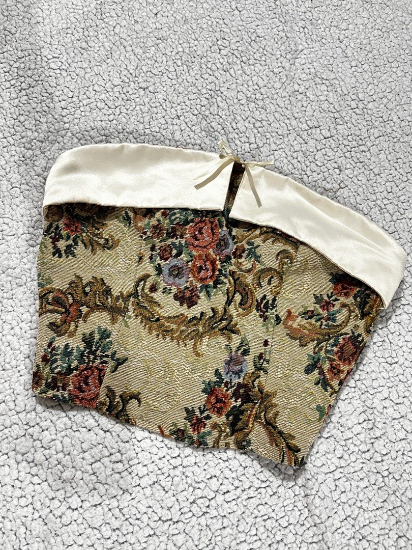 Floral Tapestry Corset Top (Category: Others Tops) located in San Fernando. Submitted by declutterbydani__ (Listing ID 1401289093, Image 1). Description: - Floral tapestry corset top - Cream satin trim - Ribbon back closure for adjustable fit - Woven fabric with detailed floral pattern - Unique and stylish design.