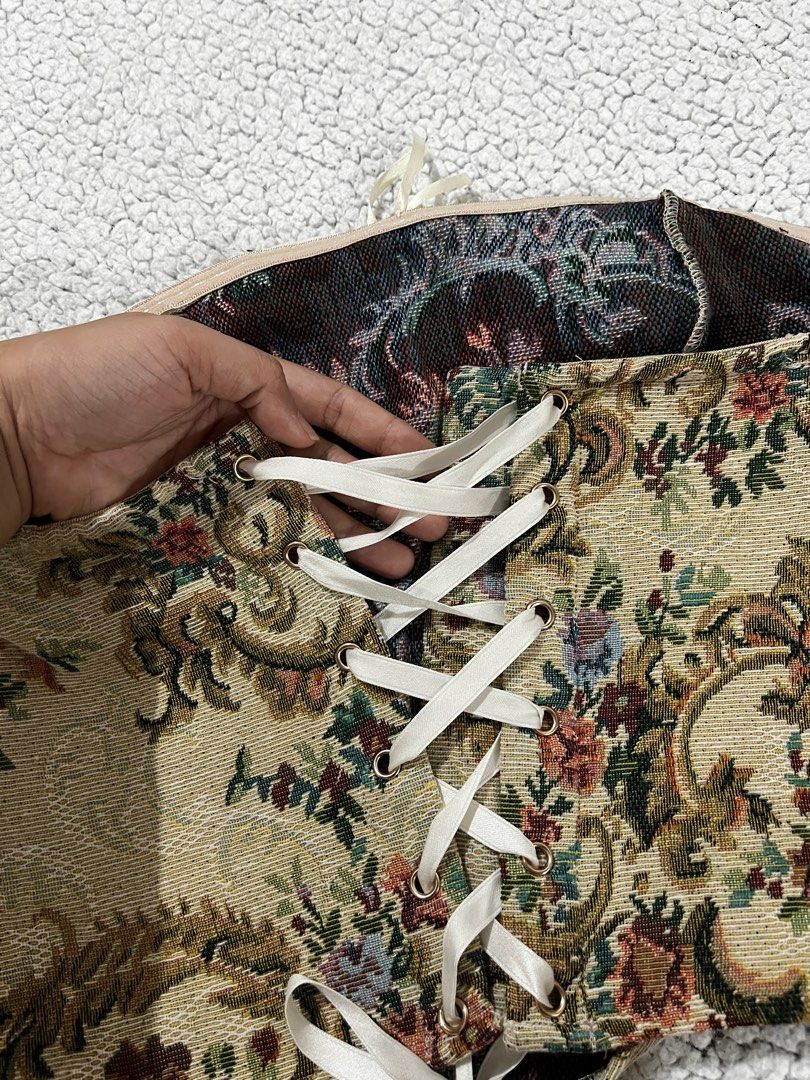 Floral Tapestry Corset Top (Category: Others Tops) located in San Fernando. Submitted by declutterbydani__ (Listing ID 1401289093, Image 2). Description: - Floral tapestry corset top - Cream satin trim - Ribbon back closure for adjustable fit - Woven fabric with detailed floral pattern - Unique and stylish design.