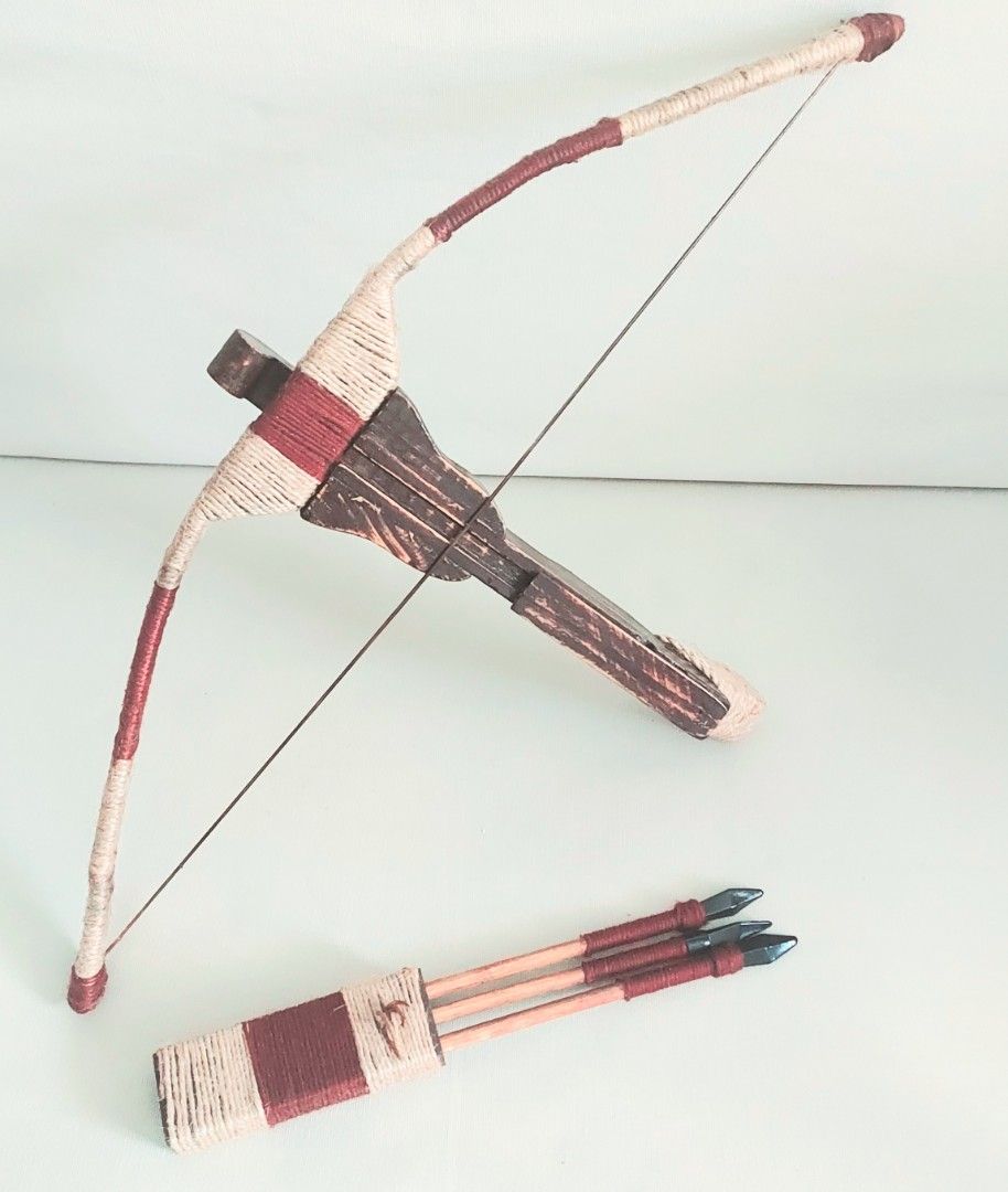 Handmade Decorative Wooden Crossbow with Arrows (Category: Wall Decor) located in Paranaque City. Submitted by ohselle (Listing ID 1401206251, Image 3). Description: Handmade wooden crossbow set, complete with three arrows and a quiver. The crossbow features a brown wooden body with decorative twine wrapping in cream and maroon. The arrows have black tips and maroon accents. The quiver is also wrapped in matching twine. A unique piece for display