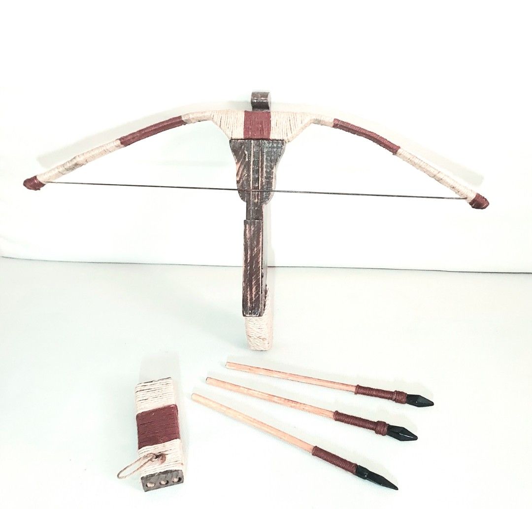 Handmade Decorative Wooden Crossbow with Arrows (Category: Wall Decor) located in Paranaque City. Submitted by ohselle (Listing ID 1401206251, Image 2). Description: Handmade wooden crossbow set, complete with three arrows and a quiver. The crossbow features a brown wooden body with decorative twine wrapping in cream and maroon. The arrows have black tips and maroon accents. The quiver is also wrapped in matching twine. A unique piece for display