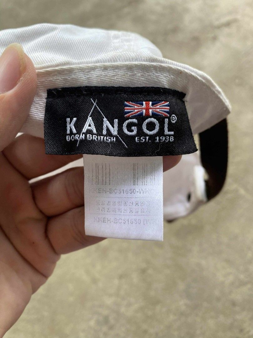 Kangol Washed Baseball Cap (Category: Caps & Hats) located in Binalbagan. Submitted by zacccmendo29558 (Listing ID 1401234986, Image 3). Description: White Kangol baseball cap. Features the Kangol logo on the front and a leather strap closure at the back. The tag indicates it is a "Washed Baseball" style. Made in the UK. The cap has a curved brim and a classic six-panel design..