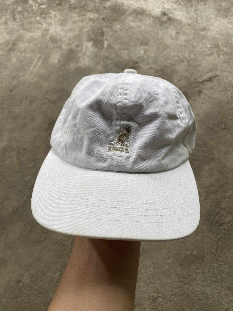 Kangol Washed Baseball Cap (Category: Caps & Hats) located in Binalbagan. Submitted by zacccmendo29558 (Listing ID 1401234986, Image 1). Description: White Kangol baseball cap. Features the Kangol logo on the front and a leather strap closure at the back. The tag indicates it is a "Washed Baseball" style. Made in the UK. The cap has a curved brim and a classic six-panel design..