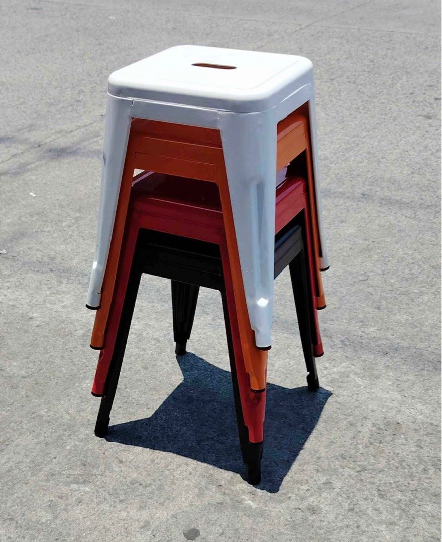 Metal Stacking low Stools (Category: Chairs) located in Manila. Submitted by mry_rfl (Listing ID 1401345445, Image 3). Description: - Set of four metal stools - Colors: Red, black, orange, and white - Square seat with rectangular cutout - Stackable design - Perfect for extra seating or accent pieces - Durable and stylish.