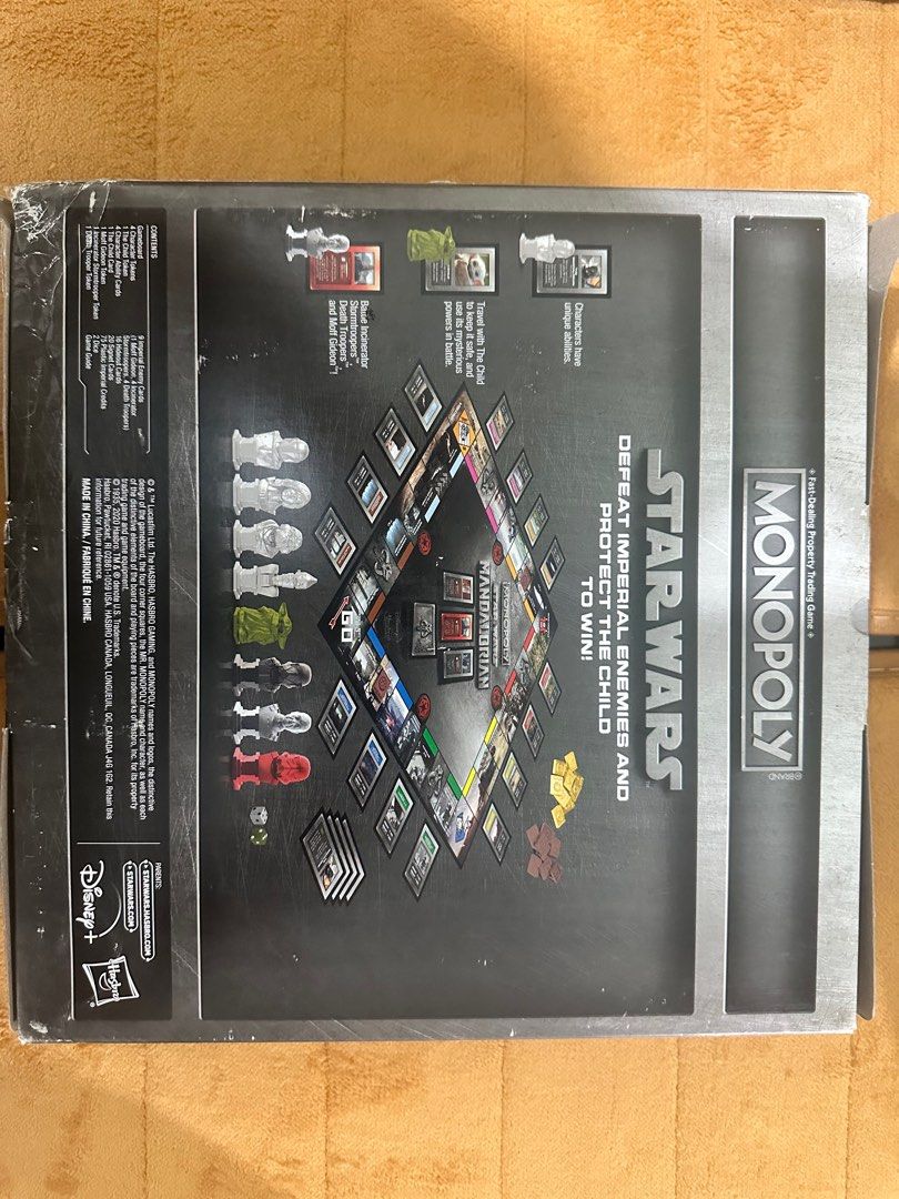 Monopoly Star Wars The Mandalorian Board Game (Category: Board Games & Puzzles) located in Manila. Submitted by kyleizs2n32753 (Listing ID 1401247303, Image 3). Description: Monopoly Star Wars The Mandalorian board game features a unique design. It includes game pieces, cards, and tokens. The game is for 2-4 players, ages 8 and up. The goal is to defeat Imperial enemies and protect the Child to win. The box shows the game board and components..