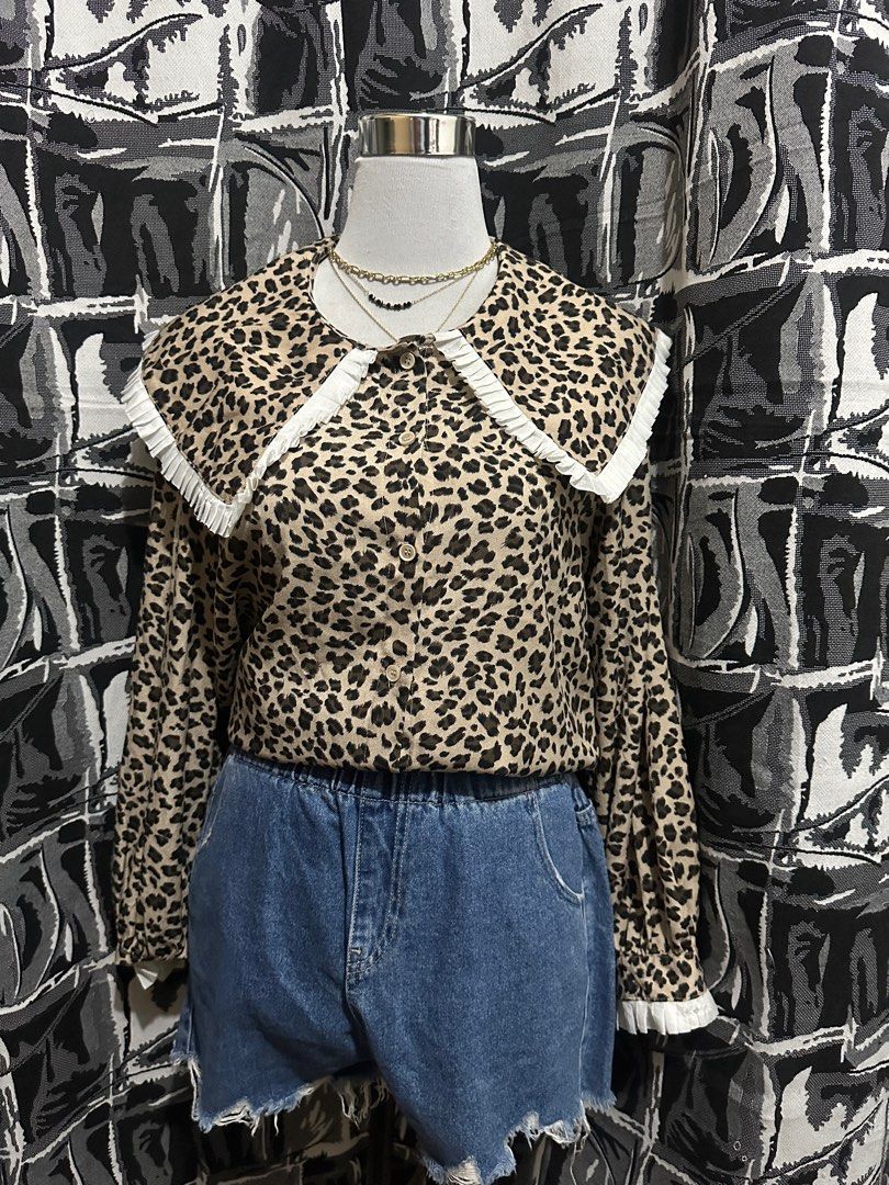 m.two Studio Leopard Print Blouse (Category: Blouses) located in Antipolo. Submitted by declutteringsizzy (Listing ID 1401295847, Image 2). Description: - M.TWO Studio blouse - Leopard print design - Unique collar with white trim - Long sleeves - Button-down front - Adds a stylish touch to any outfit .