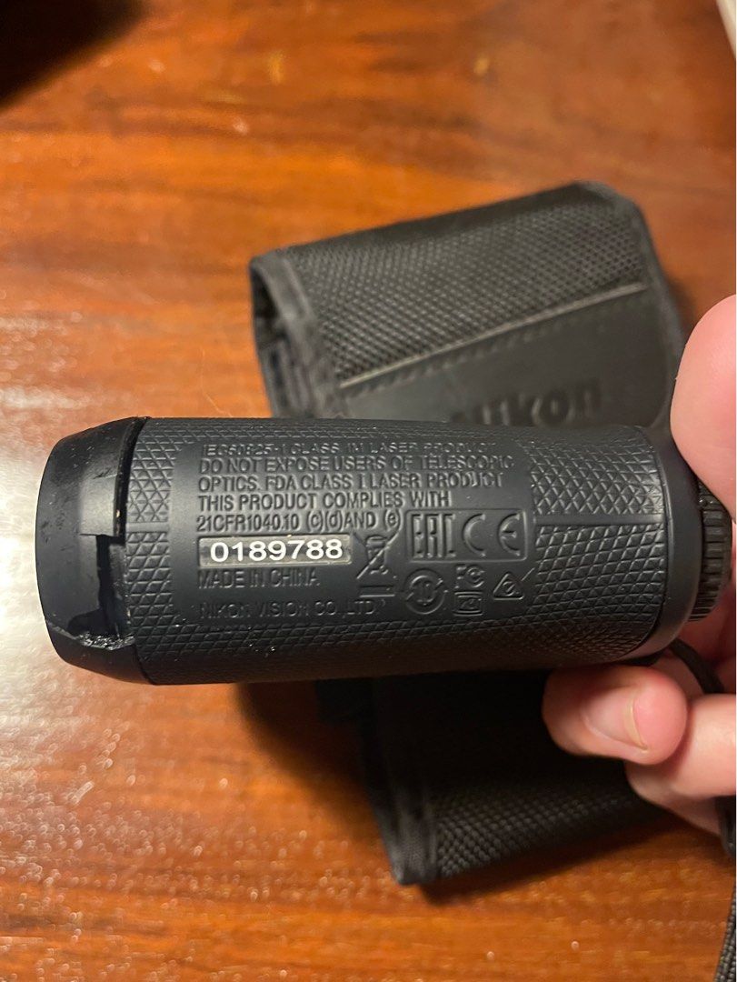Nikon ACULON Rangefinder (Category: Golf) located in Quezon City. Submitted by d.archives (Listing ID 1401351050, Image 2). Description: Nikon ACULON rangefinder with carrying case. The rangefinder is black and includes a wrist strap. The model number is ACULON, and the serial number is 0189788. The carrying case is also black and features the Nikon logo. RFS: use garmin minor flaw: plastic cracked but does not affect performance of the rangefind