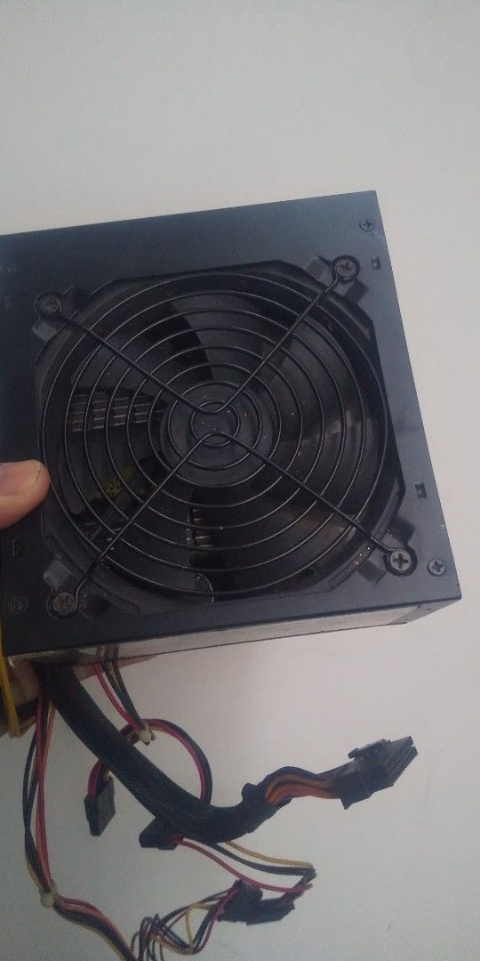 Power Choice PC-500W Power Supply (Category: Computer Parts) located in Carmona. Submitted by rpute (Listing ID 1401253684, Image 3). Description: Power Choice PC-500W switching power supply. Features AC input of 230V, 50Hz, 4A. Provides various DC output voltages including +12V, +5V, and +3.3V. Includes multiple connectors for different components. The fan is visible on the top. Model number is PC-500W..