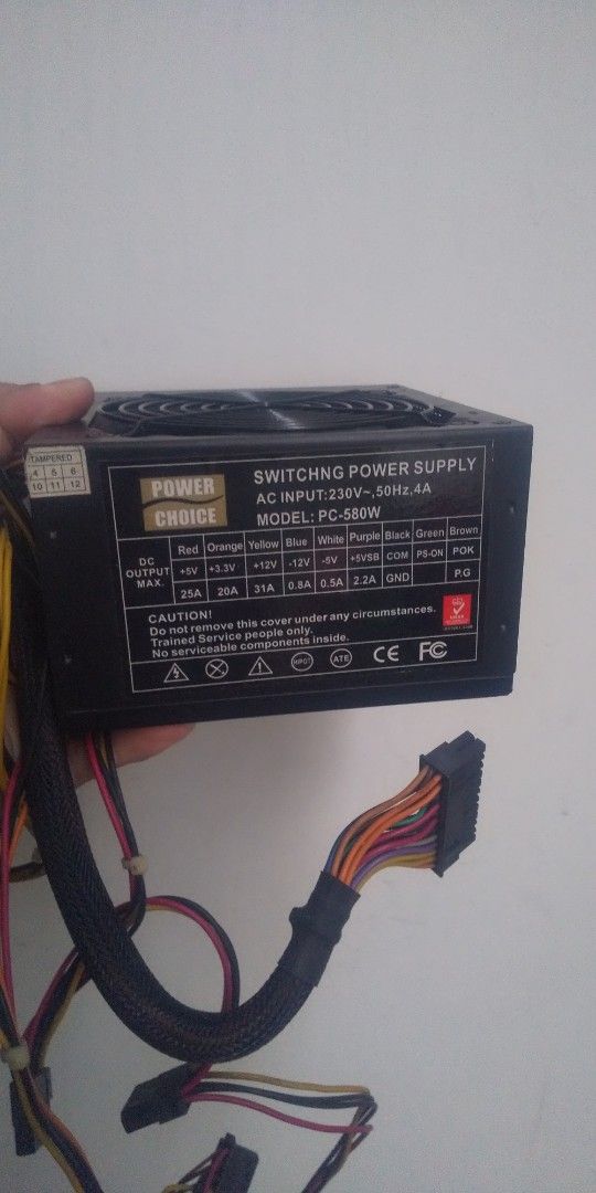 Power Choice PC-500W Power Supply (Category: Computer Parts) located in Carmona. Submitted by rpute (Listing ID 1401253684, Image 1). Description: Power Choice PC-500W switching power supply. Features AC input of 230V, 50Hz, 4A. Provides various DC output voltages including +12V, +5V, and +3.3V. Includes multiple connectors for different components. The fan is visible on the top. Model number is PC-500W..