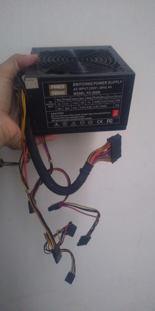 Power Choice PC-500W Power Supply (Category: Computer Parts) located in Carmona. Submitted by rpute (Listing ID 1401253684, Image 2). Description: Power Choice PC-500W switching power supply. Features AC input of 230V, 50Hz, 4A. Provides various DC output voltages including +12V, +5V, and +3.3V. Includes multiple connectors for different components. The fan is visible on the top. Model number is PC-500W..