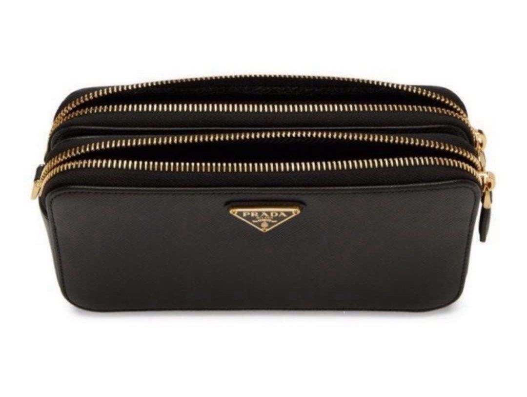Prada Double Zip Crossbody Bag (Category: Luxury Bags & Wallets) located in Manila. Submitted by decluterthings888 (Listing ID 1401168124, Image 2). Description: - Black Prada crossbody bag - Gold chain strap - Double-zip closure for multiple compartments - Iconic Prada triangle logo - Perfect for everyday use.
