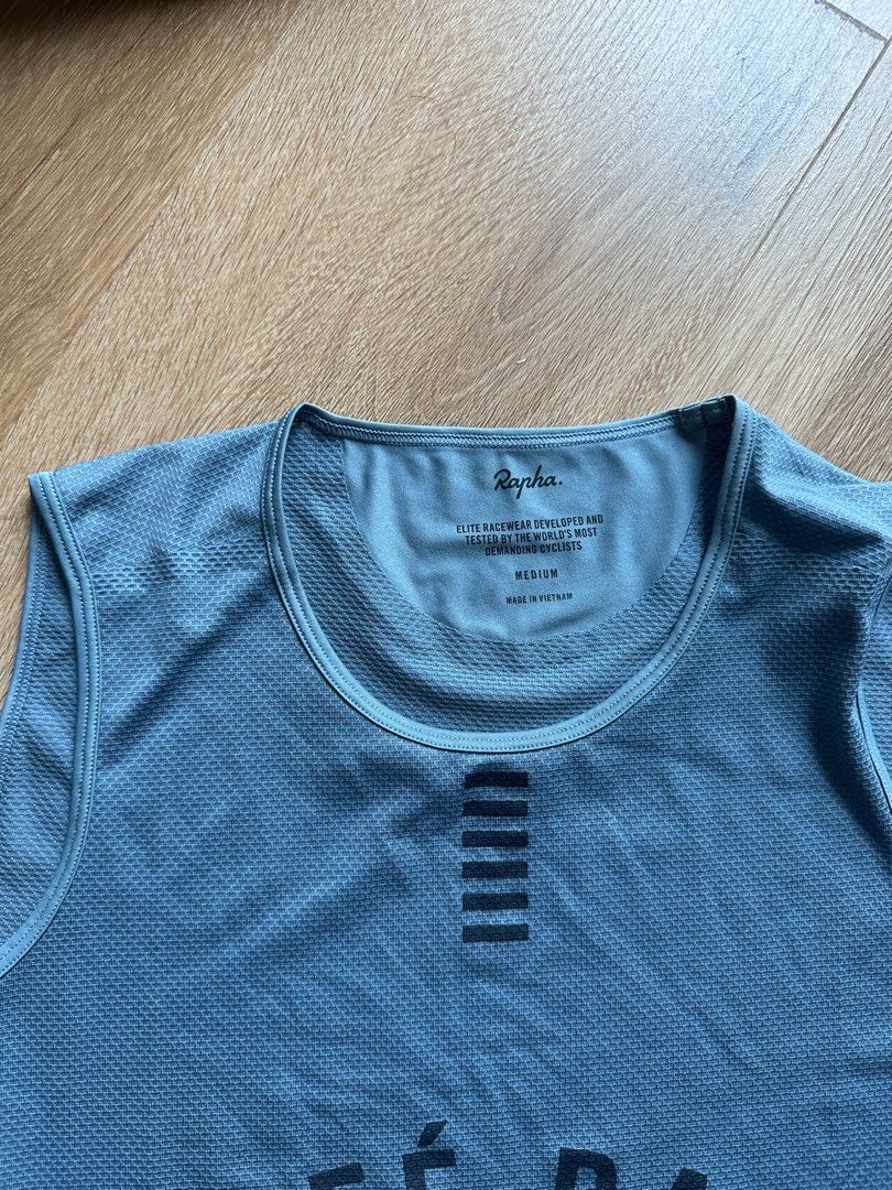 Rapha Pro Team Cafe Raid Cycling Jersey - Medium (Category: Activewear) located in Quezon City. Submitted by nikoabl (Listing ID 1401199550, Image 2). Description: Rapha Pro Team cycling jersey in a light blue color. Features the "Cafe Raid" graphic on the front. Size is Medium. Includes care instructions. The jersey has a unique design with a textured fabric and a racerback style. The back of the jersey has a Pro Team label. Rfs: Quit Cycling.
