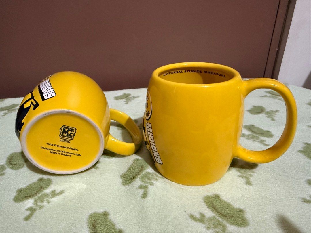 Universal Studios SG Minions Mug (900 each) (Category: Coffee & Tea Tableware) located in Quezon City. Submitted by skyeseller (Listing ID 1401255620, Image 2). Description: - Universal Studios SG Minions Mug - Features a bright yellow color - Adorned with Otto and other Minion graphics - In good condition - Perfect for Minions fans and collectors.